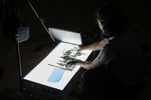 woman projecting images with a light box